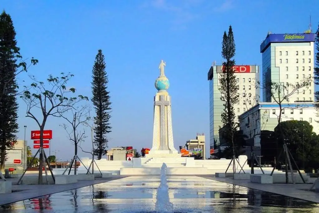 Monument with fountain and buildings.