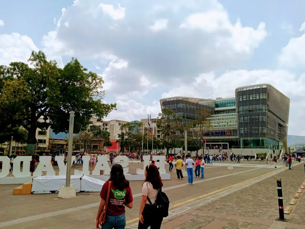 People walking near modern buildings outdoors.