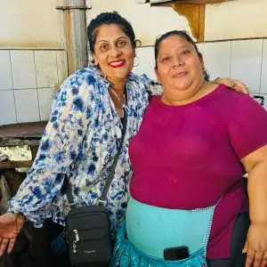 Two women in a kitchen setting.